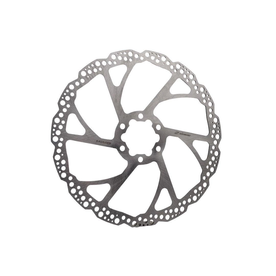 The Warp9 220mm EMoto Rear Rotor, a silver bicycle disc brake from Warp9, features a circular design with cutouts and perforated edges, elegantly displayed on a plain white background.