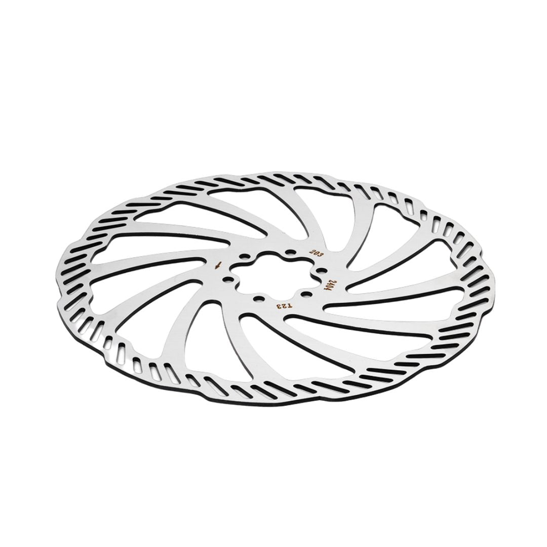 The Falcon Pro Brake Disc by 79Bike is a silver, circular rotor for Sur-Ron Light Bee X, featuring a slotted and wavy design with ventilation cutouts. It has alternating thick and thin edge segments to ensure high temperature resistance and reduce weight.