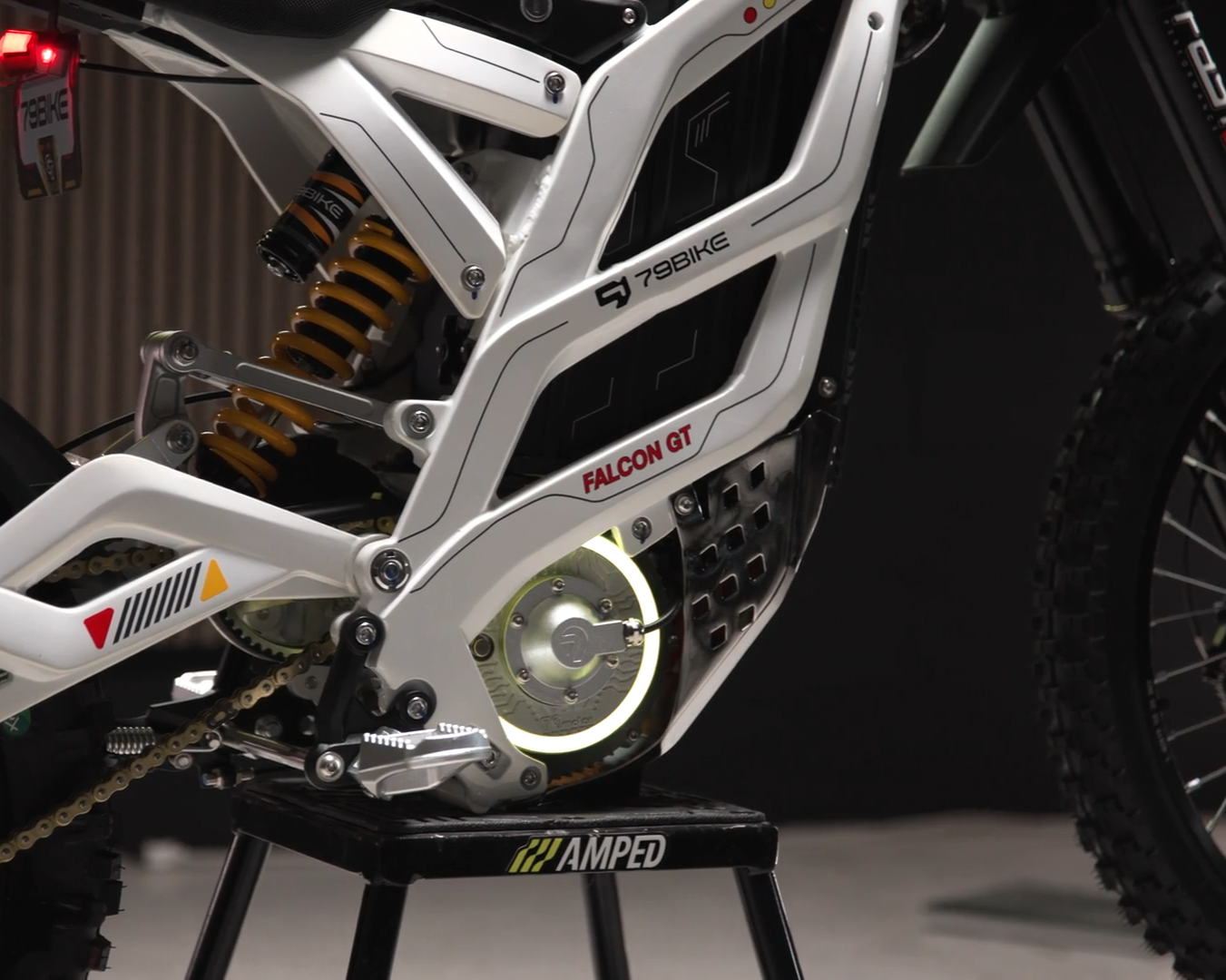 Close-up of a dirt bike with visible branding on a dark background