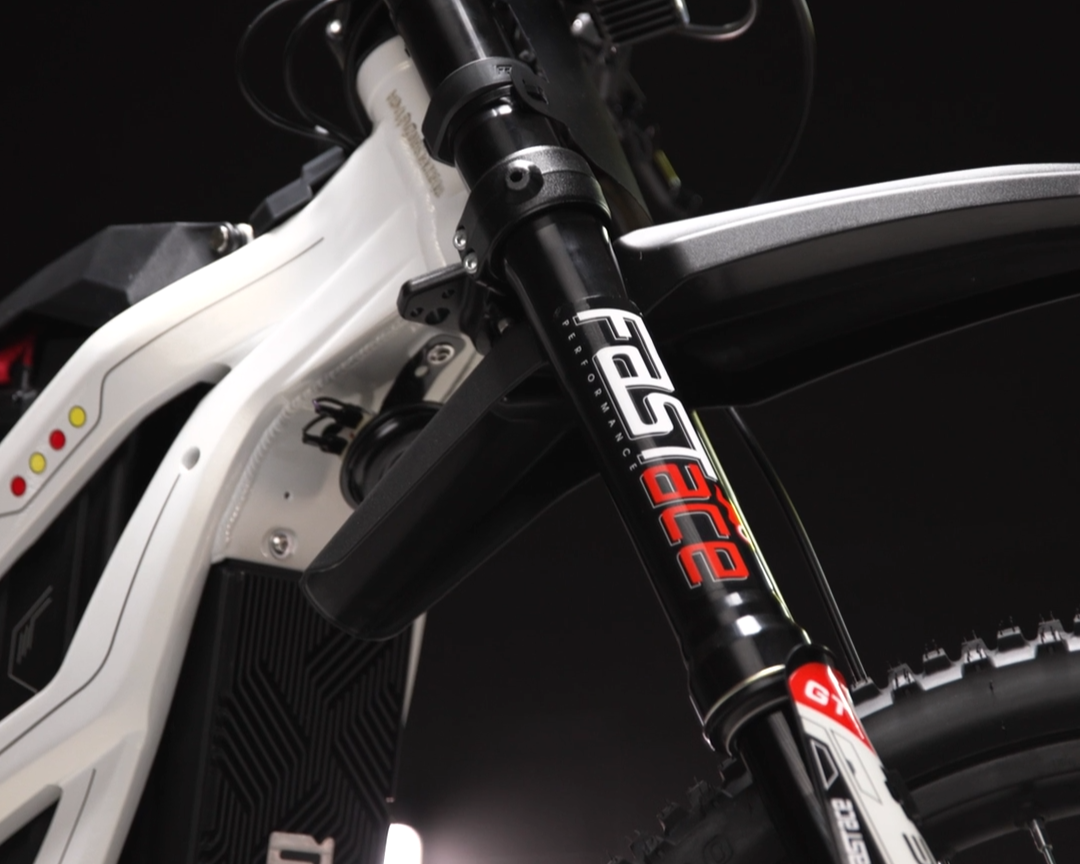 Close-up of a bicycle with a focus on the suspension fork, featuring branding.