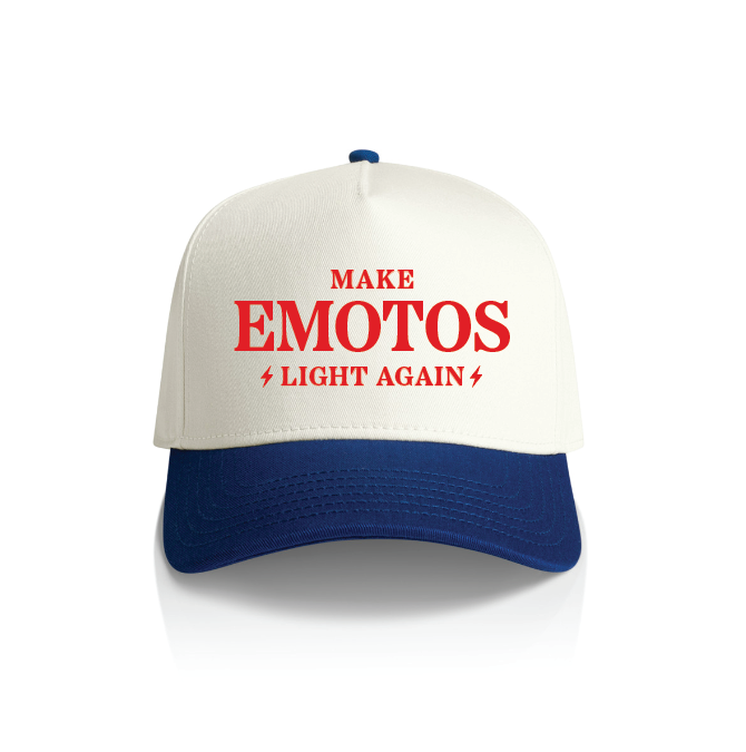 The Amped Bikes MELA HAT is a Falcon Pro snapback with a white front, blue bill, and bold red MAKE EMOTOS LIGHT AGAIN text, highlighted by small lightning bolt symbols flanking LIGHT AGAIN.