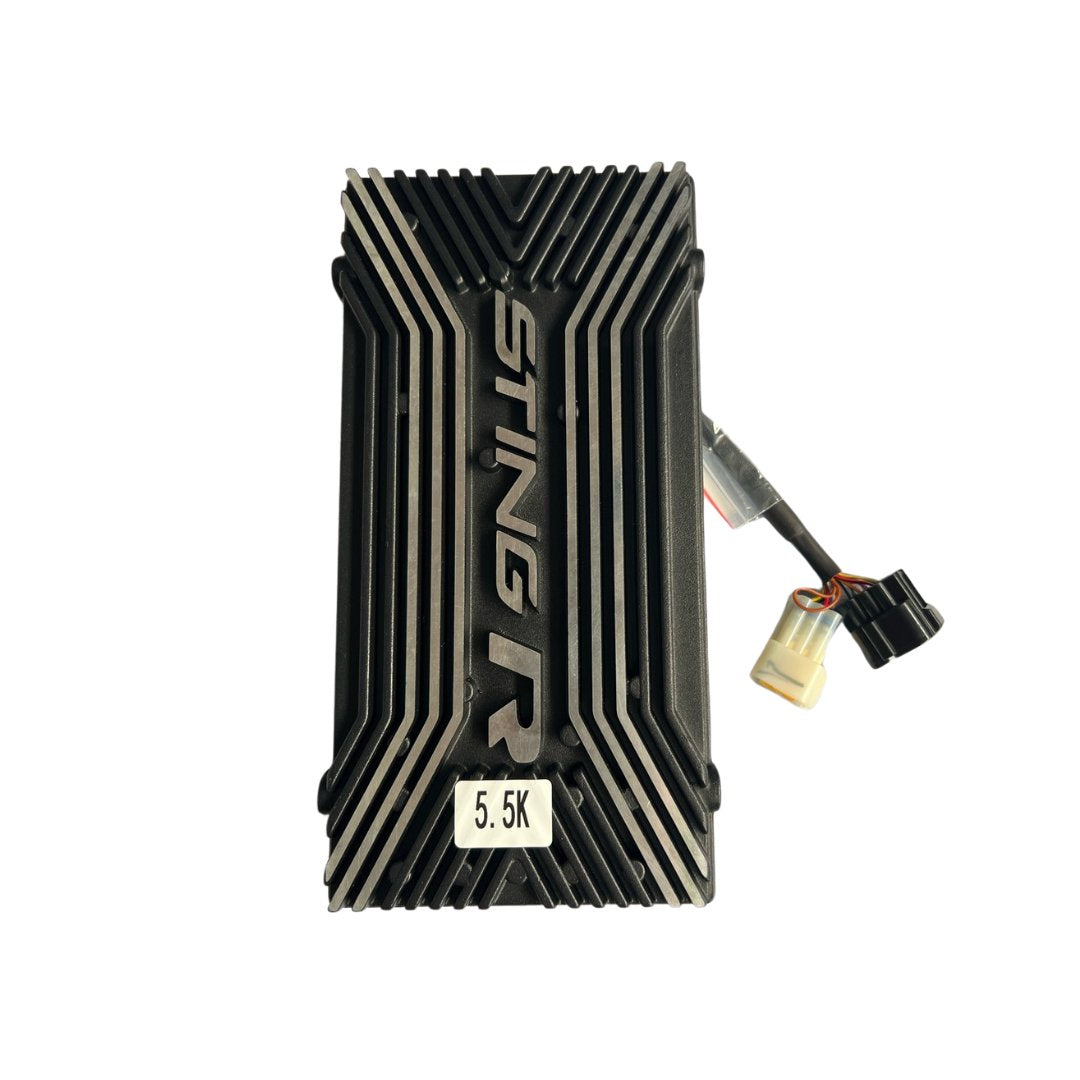 A rectangular black Talaria Controller with silver accents and ridges proudly displays Talaria embossed on its surface, accompanied by a 5.5K label. Wires featuring beige and black connectors extend from one side, merging innovation with style.