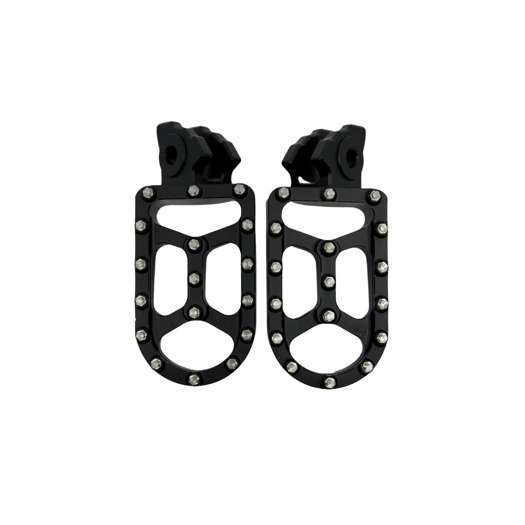 A pair of Talaria MX5 Footpegs by Talaria, black metal OEM replacements with multiple rivets and a rugged open-frame design for high-performance riding, shown side by side on a white background.