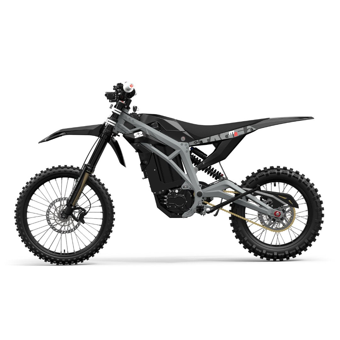 The Razor Stage2, M2 72V Electric Dirt Bike is a sleek, modern electric motorcycle in a black and gray color scheme. It boasts knobby tires, visible suspension, and a minimalist frame, ideal for off-road adventures with its swappable lithium battery.