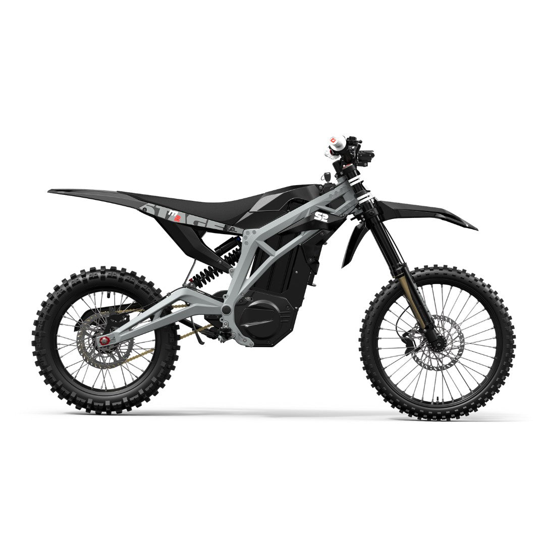 The Razor Stage2 M2 72V Electric Dirt Bike is elegantly displayed in black and gray, showcasing its rugged tires against a white backdrop. It flaunts a minimalist design, reaches speeds of 65 MPH, and includes a swappable lithium battery for longer rides.