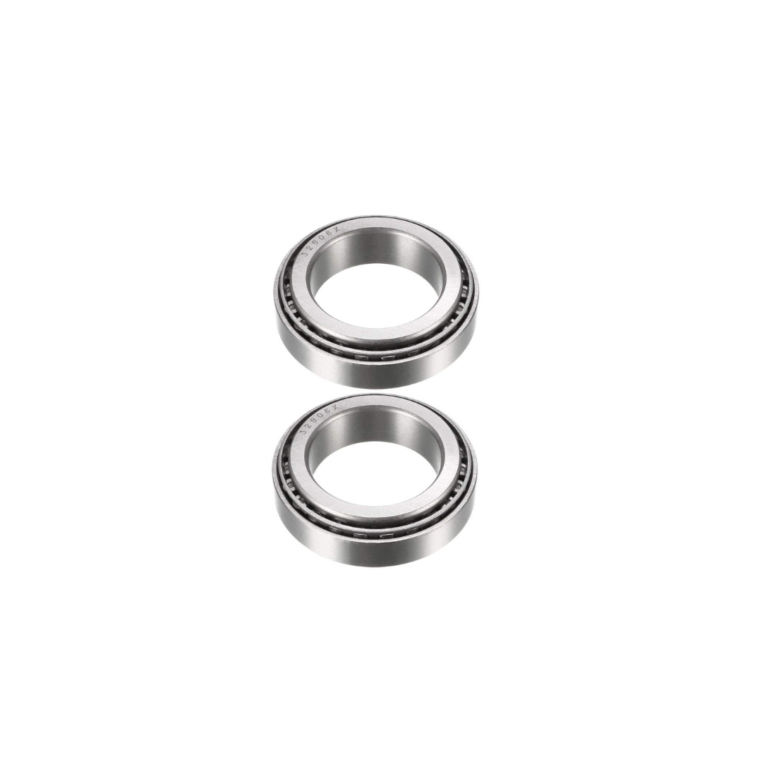 Two metal ball bearings from the Amped Bikes Headset Bearing Kit stand vertically against a white background, showcasing precision craftsmanship similar to high-performance tapered roller bearings with visible grooves.