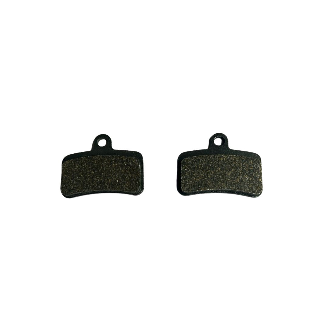 Two Talaria MX5 Brake Pads, designed for the Talaria Sting MX5 Pro, feature a rectangular shape with curved edges and small top holes. They are side by side on a white background and crafted with an advanced compound for optimal performance.