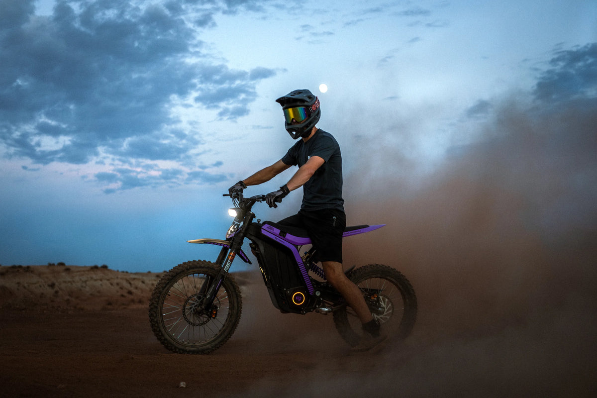 79Bike Lynx electric dirt bike, side profile in desert dust at dusk