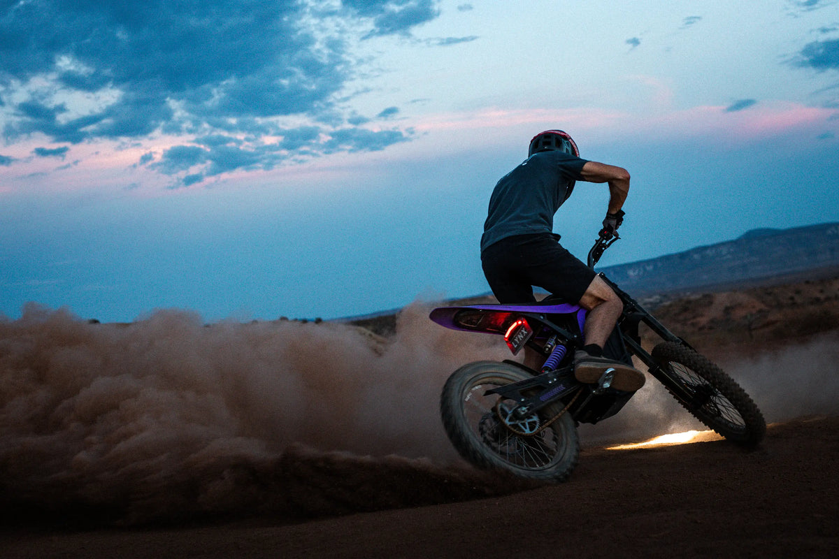 79Bike Lynx sliding through dirt, side view