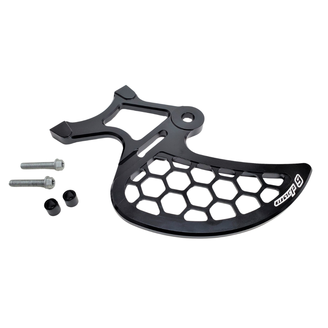 A black metal bike chain guard with a honeycomb pattern, two screws, and small cylindrical pieces is displayed on a white background alongside the Warp 9 Rear Disc Guard by Warp9, designed for a 220mm rotor.
