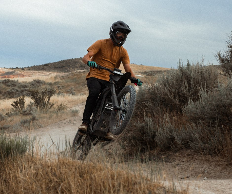 Rider on a trail wheeling the E Ride Pro SS