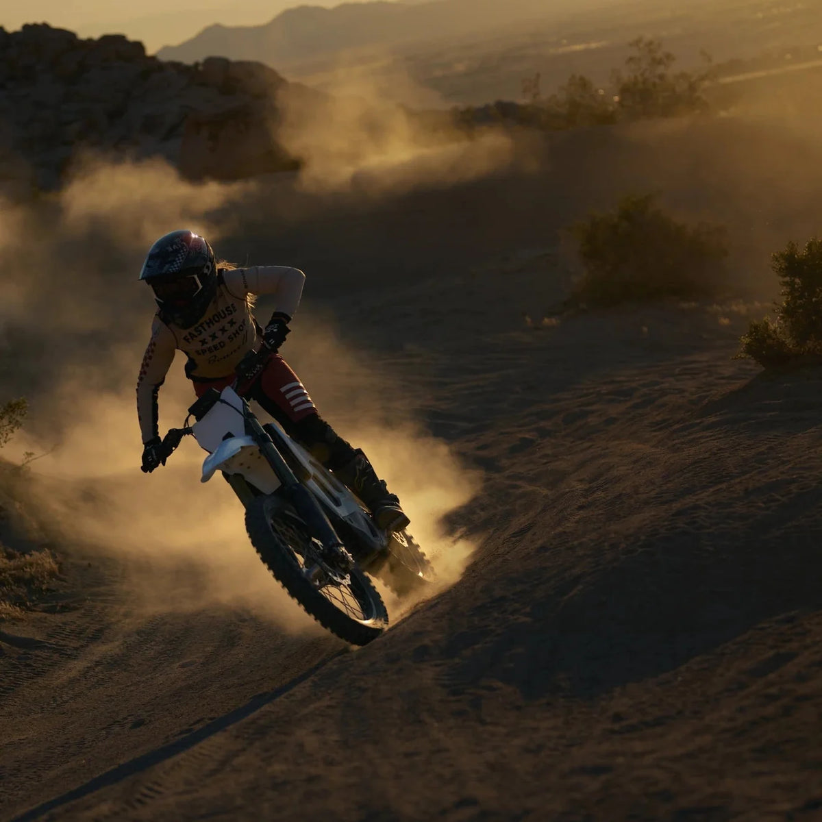 Bonnell 805 RX rider roosting a desert berm at dusk