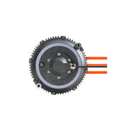 The 79Bike Falcon Pro Motor is a round, black mechanical device with a patterned center and bolts, connected to three orange and black cables on the right, ensuring smooth power delivery against a white background.