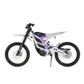 The 79Bike Falcon Pro is a 72V electric dirt bike with a sleek white and black design accented in purple, large off-road tires, and a minimalist frame.