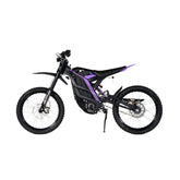 The 79Bike Falcon Pro, a 72V electric dirt bike, showcases a black frame with purple accents. It features off-road tires, front and rear suspension, and a minimalist seat. Displayed in side profile on a white background.