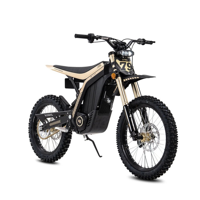 79Bike Lynx electric dirt bike in gold, front three-quarter angle with LED headlight, number plate marked 79, and gold front forks.