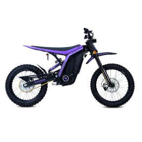 79Bike Lynx electric dirt bike in purple and black, side view showing the frame, rear coil-over suspension, chain drive, and knobby off-road tires.