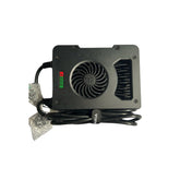 The Talaria Charger is a black electronic device resembling the Talaria OEM Battery Charger. It includes a fan, wiring, and a control panel with red and green indicators. Partially wrapped in bubble wrap, this 12 amp charger by Talaria is designed for efficiency.